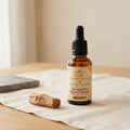 Pure sandalwood oil bottle by Jai Gurudev Upkaran Bhandar with raw chandan wood - for pooja, meditation and skincare