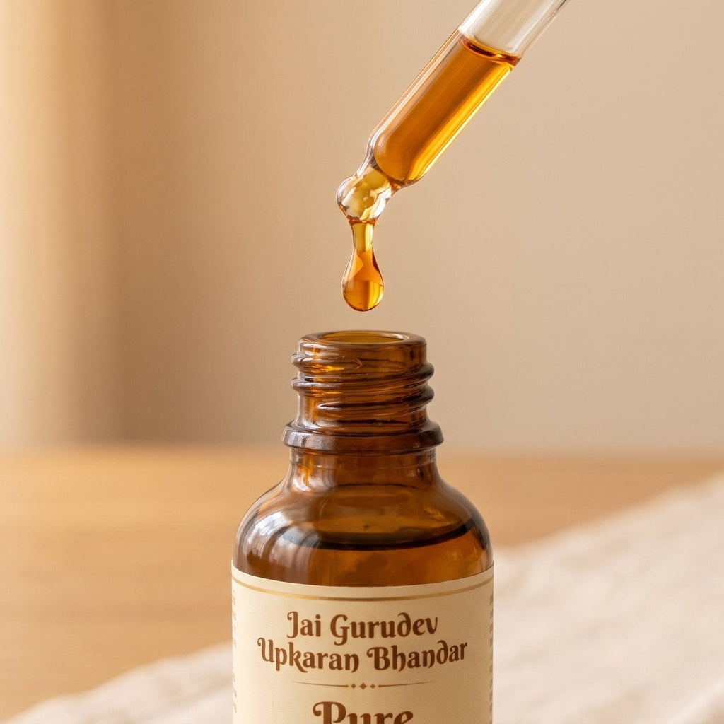 Golden drop of pure chandan sandalwood oil from glass dropper - aromatherapy and spiritual use