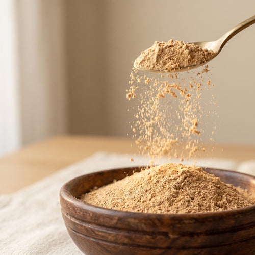 Fine pure sandalwood powder cascading from spoon - chandan for skincare ubtan and pooja paste